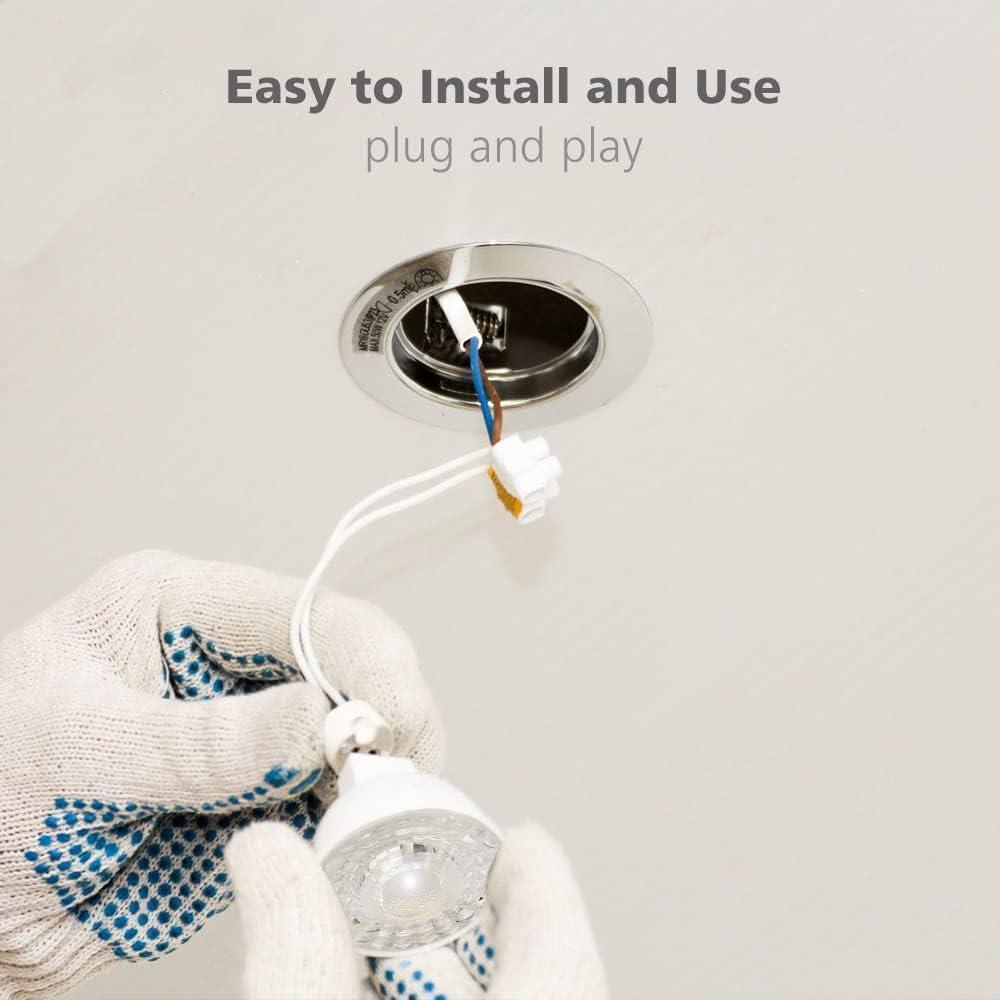 Gloved hands installing an LED light bulb into a recessed ceiling fixture, easy plug and play