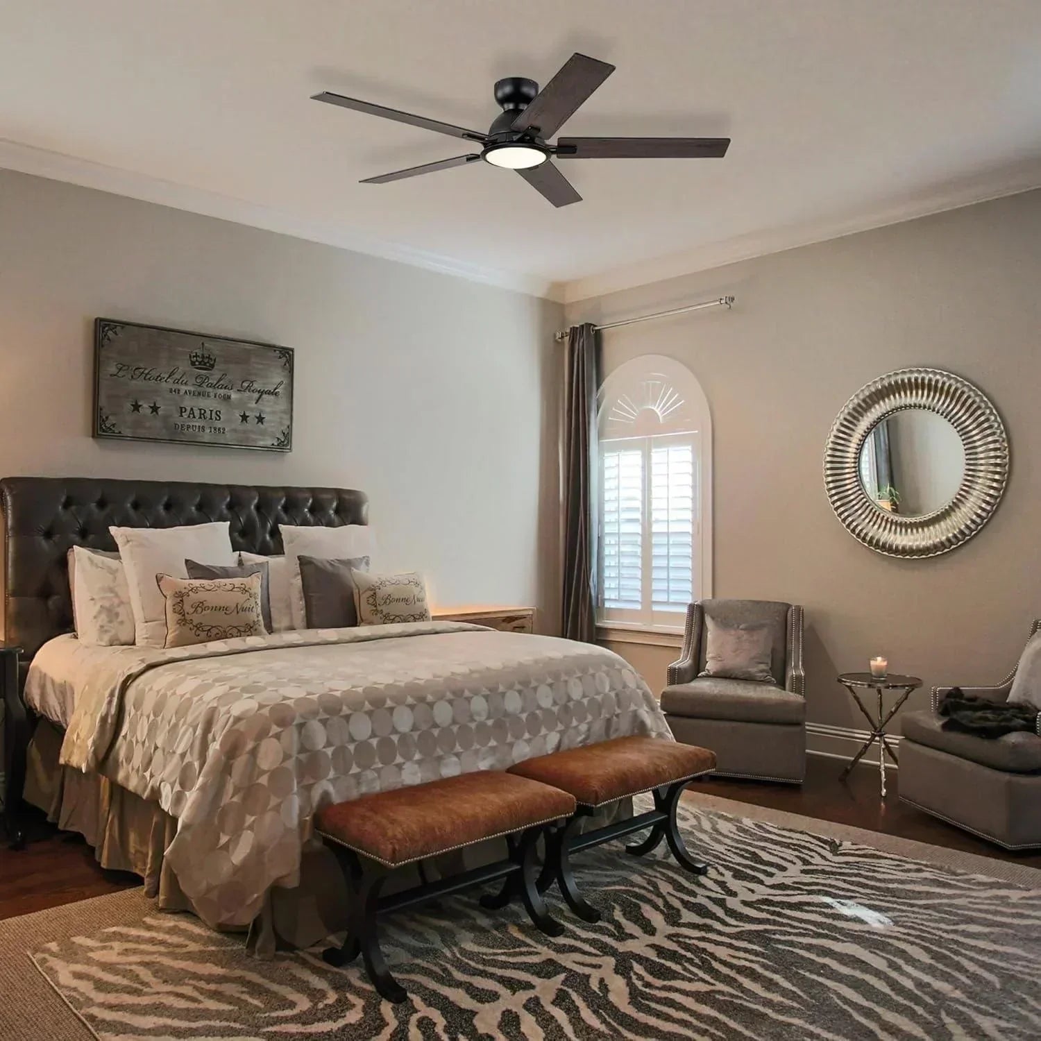 Modern bedroom with LED ceiling fan, neutral decor, and stylish wall mirror
