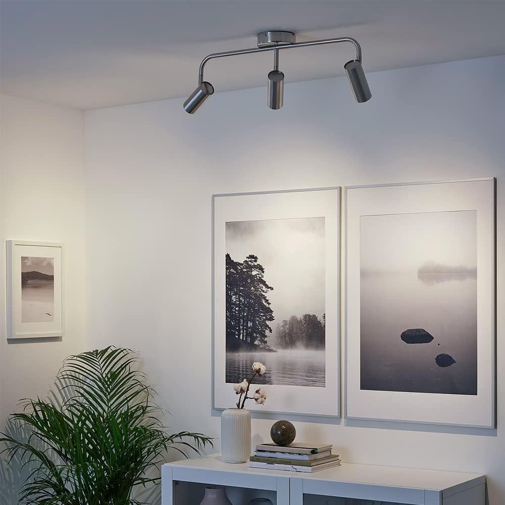 Modern LED ceiling light fixture with adjustable spotlights in a stylish living room.