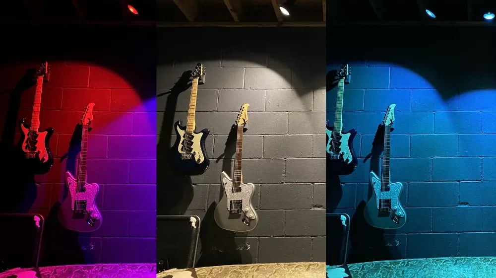 Wall-mounted electric guitars illuminated by RGB LED light bulbs in red, white, and blue